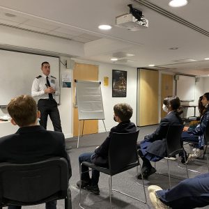 A security officer discusses his role in front of students