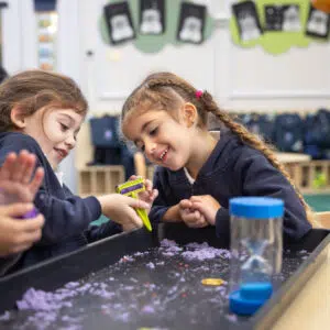 Two young female students engaging at the Knightsbridge School private preschool